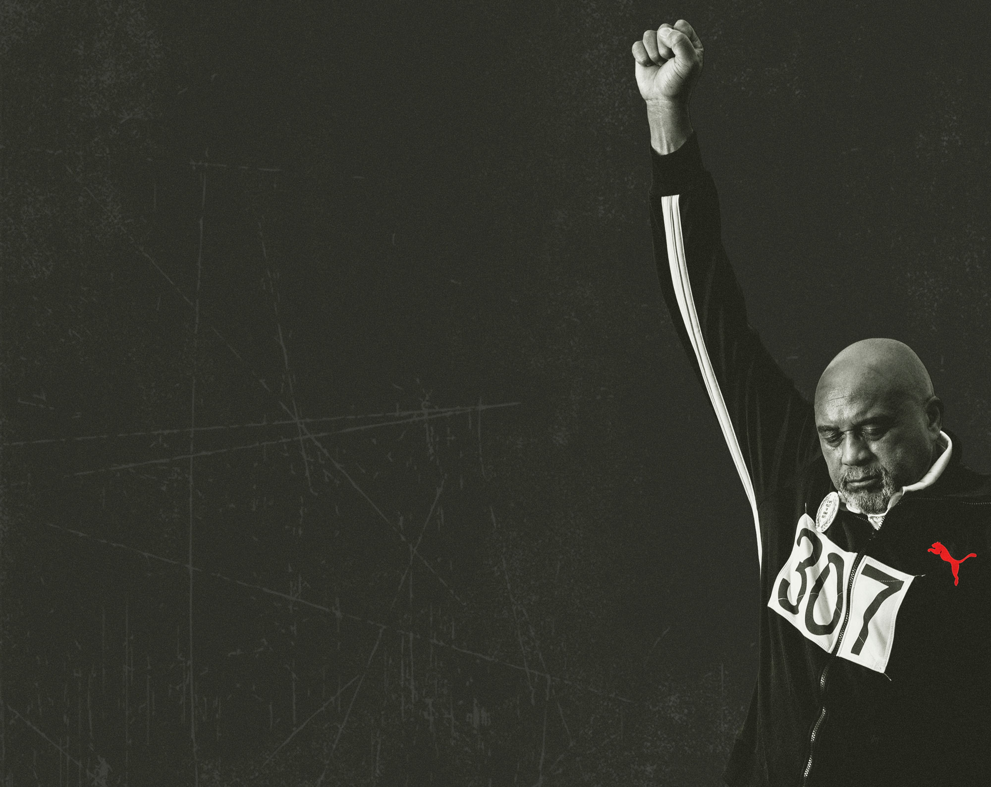 Tommie Smith with a fist raised in protest
